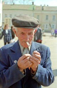 old man lighting a cigarette